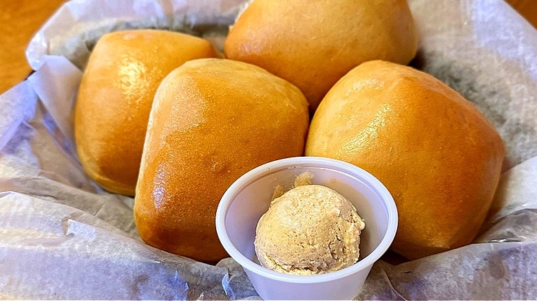 A basket of fresh baked rolls and cinnamon honey butter from Texas Roadhouse