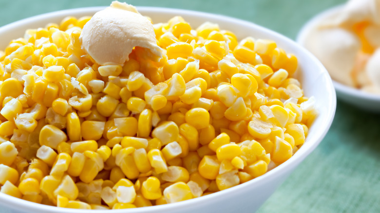 Sweet corn kernels in bowl with butter on top