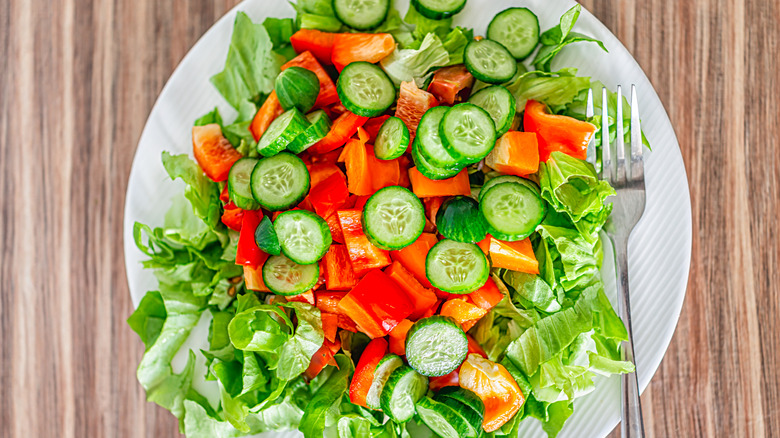 A plate of cucumber chopped salad with fork