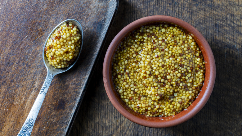 Dijon mustard in a bowl with a spoon next to it