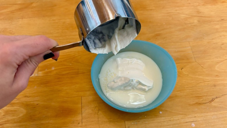 Sour cream poured into milk